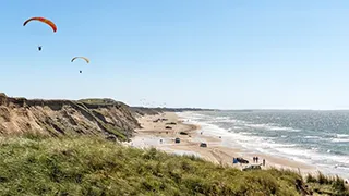 Strand in der Nähe von Narhval Poolhus