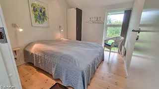 Schlafzimmer in Tjørne Mosaikhus